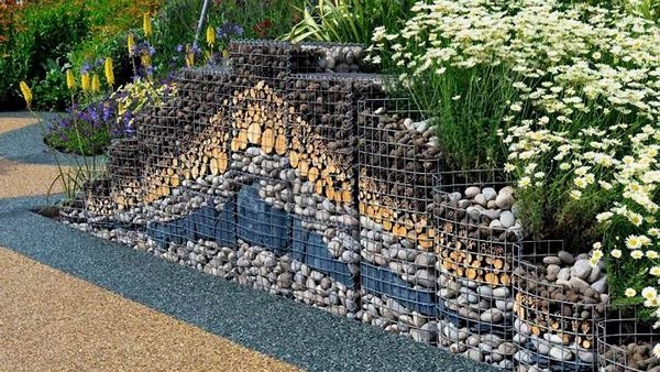 Beautiful series of blue rock gabion retaining walls in a large backyard