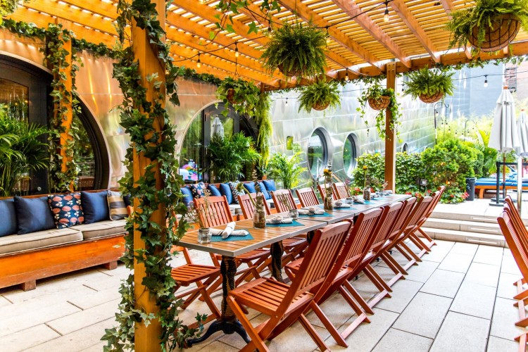 Cozy outdoor living space with shaded patio structure, belgard paver decking