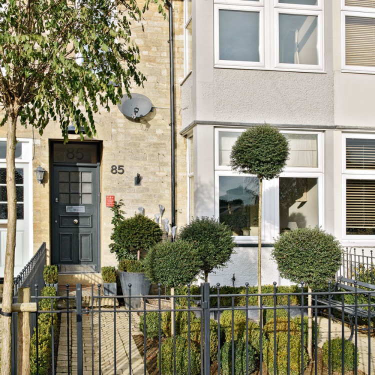 Garden gate ideas and inspiration: a boxwood garden with beautiful topiaries and balls