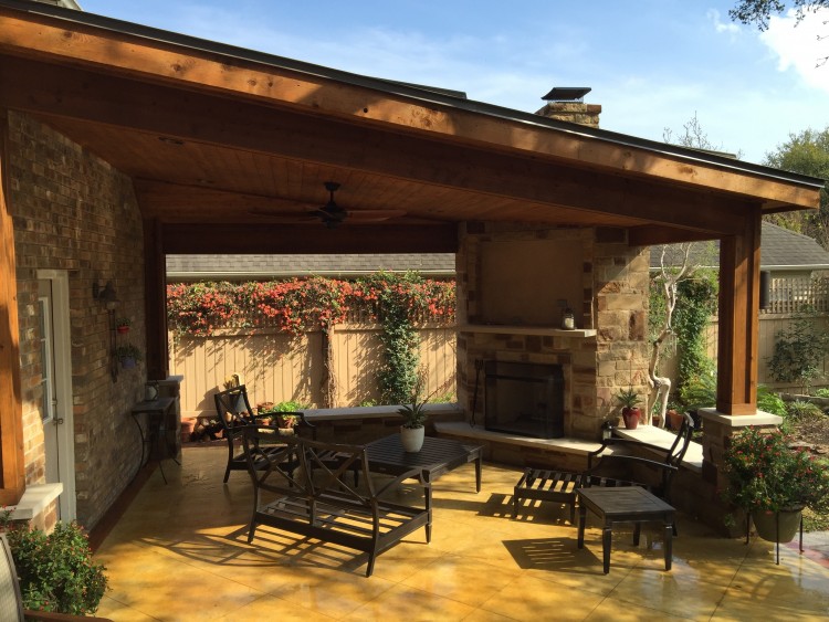 Drees Homes Winfield outdoor living area with corner fireplace, shiplap ceiling, and fan