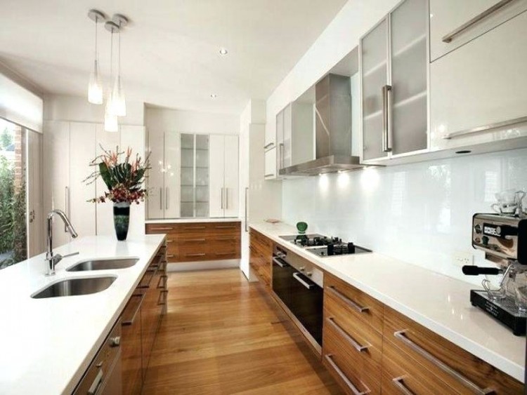 A modish large kitchen with a long center island featuring a marble countertop