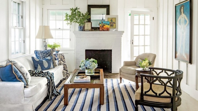 A Moroccan rug adds warmth to a matte grey bedroom large plants accent the space