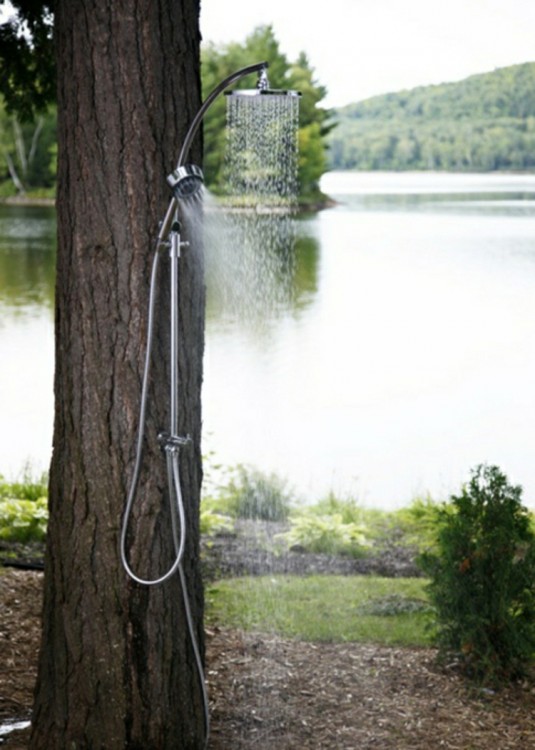 A photograph of a new design unique partial outdoor bathroom of a beautiful tropical resort, with lovely natural view of a small open air garden full of