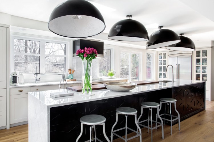 Stunning white and black modern kitchen with medium dark wood flooring