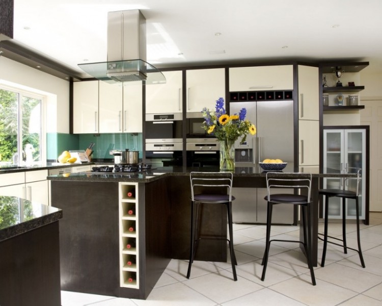 This modern toe kick drawer for wine storage has easy access below the white cabinets