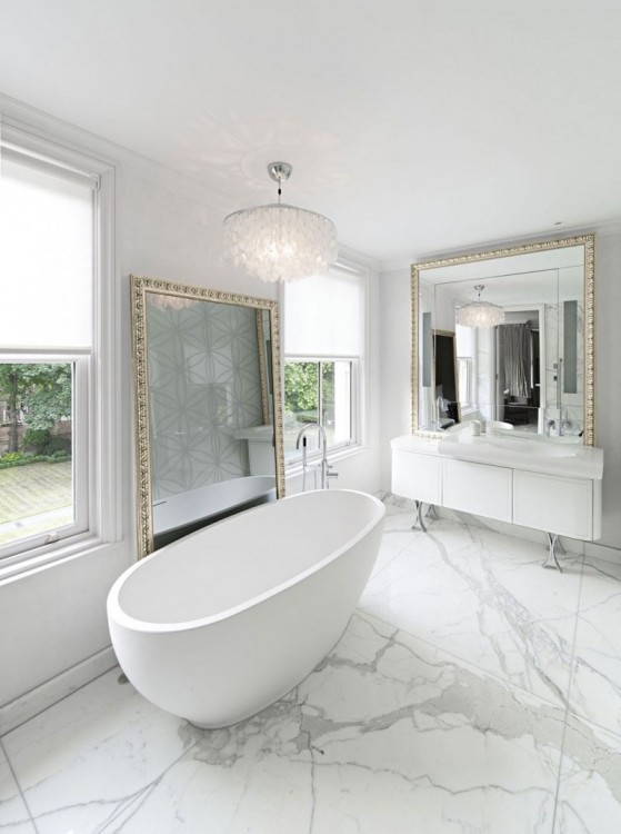 An oval, freestanding tub was fitted to stand diagonally across from a spacious shower lined with fashionable tiles