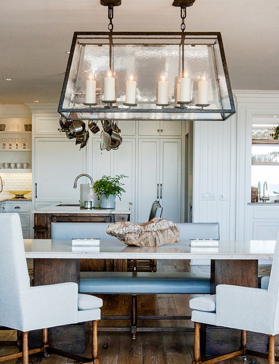 Beach dining room with unique chandelier and glass windows and door