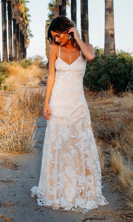 A pink floral print wedding dress with tulle overlay