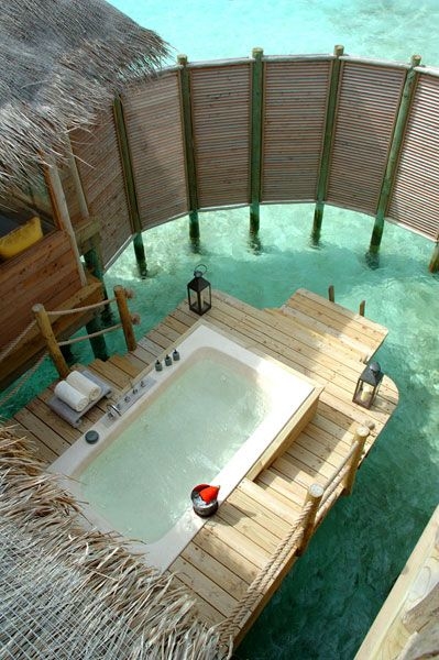 Woman enjoying water from outdoor shower showering in private overwater bungalow hotel in Tahiti, luxury spa resort travel vacation Foto, Poster,