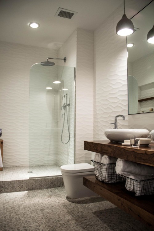 The deluxe bathroom has a deep soaking tub and vertically positioned subway  tiles