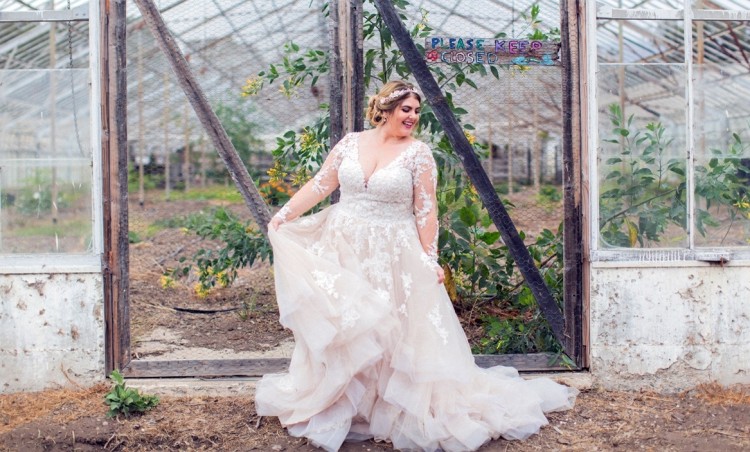 plus size bride wearing ballgown wedding dress with sleeves